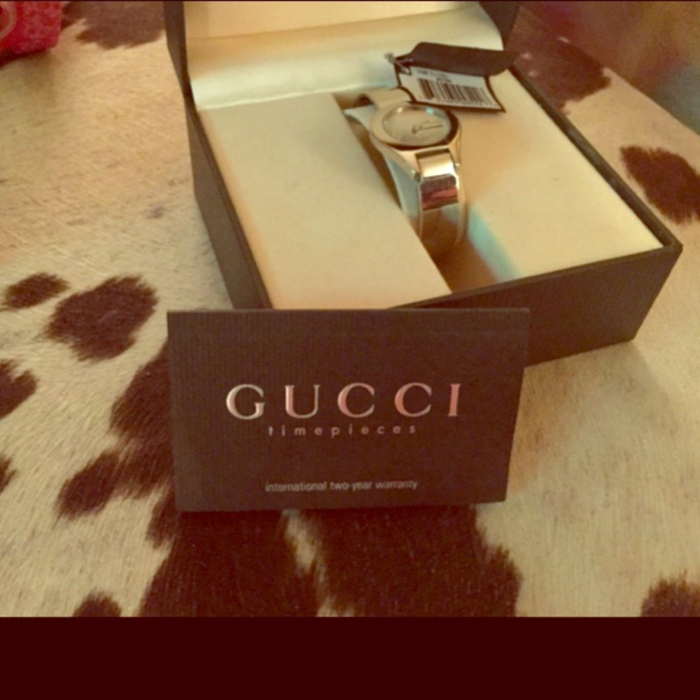 Women’s silver Gucci buckle clasp watch